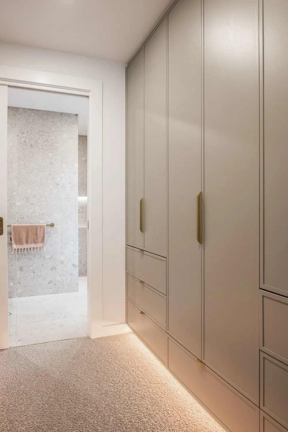 Shower with brass fixtures and stone tiling